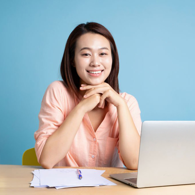Photo of young Asian businesswoman on blue background